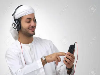 25068342-Arabian-guy-listening-to-music-using-headphones-isolated-Stock-Photo.jpg